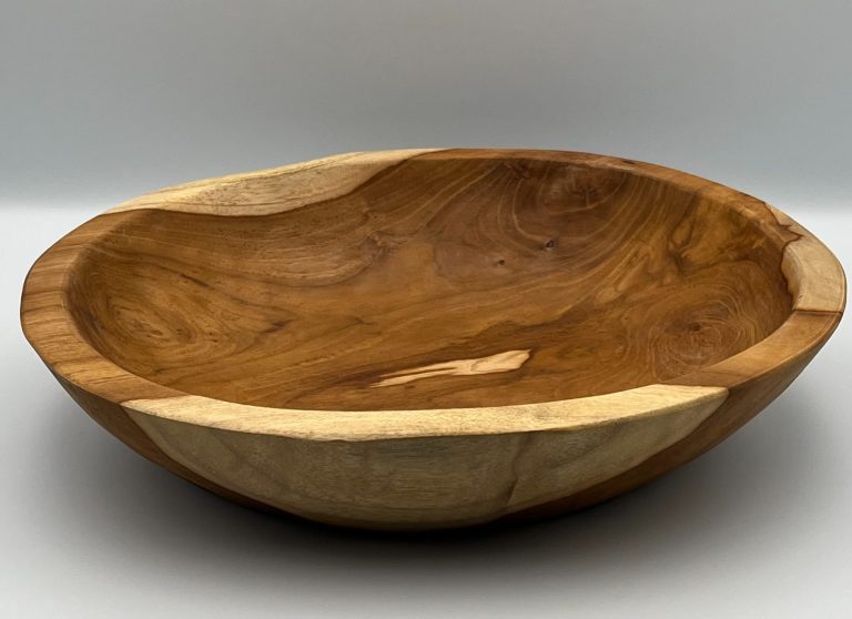 Wooden bowl with a smooth, natural finish and a curved, rustic shape.